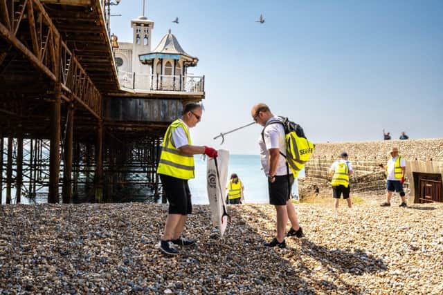 Beach cleaners collecting litter near the Brighton pier 