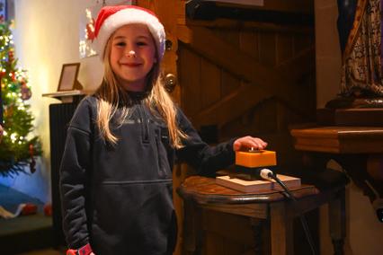 Isabelle Freeman pressing the button to launch the Christmas Tree Festival at St Mary’s Church, East Preston