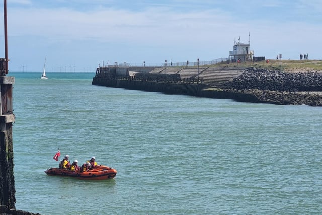 Shoreham RNLI's ILB launching with the National Coastwatch Shoreham tower in the distance