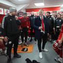 Crawley Town manager Scott Lindsey celebrates with his staff and players in the dressing room after the match | Telephoto Images