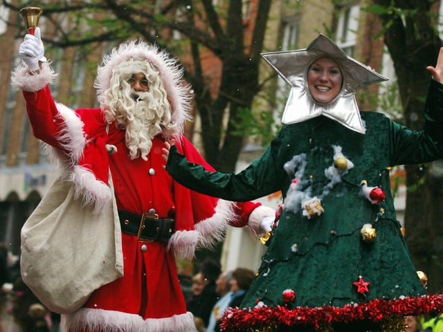 Father Christmas and his festive tree entertaining the crowds in 2008