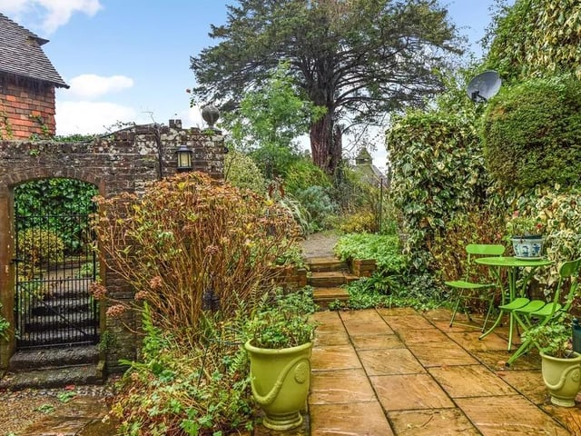 The garden has several paved seating and dining areas