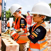 Young visitors try their hand at bricklaying in the Thakeham Family Area at Festival of Speed
