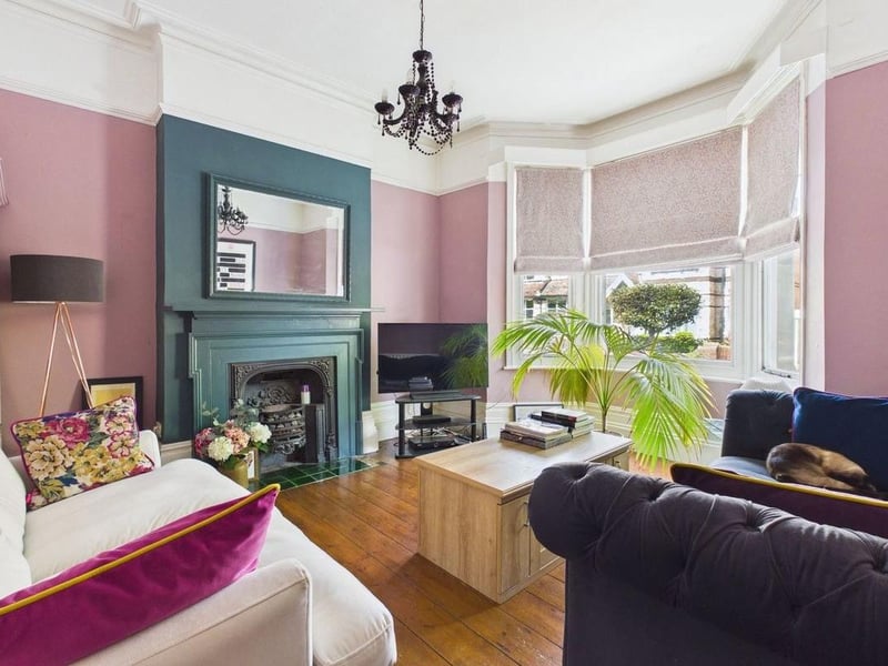 The bay-fronted living room is a bright and elegant space with a feature fireplace