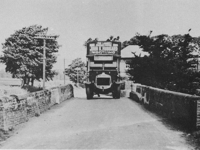 The no.31 bus travelling through Goring to Worthing, advertising the well-known Hubbard store