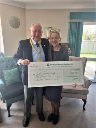 Catherine Brewster, general manager of Mortain Place presenting the cheque to Frederick Smith, chairman of Just Friends Charity