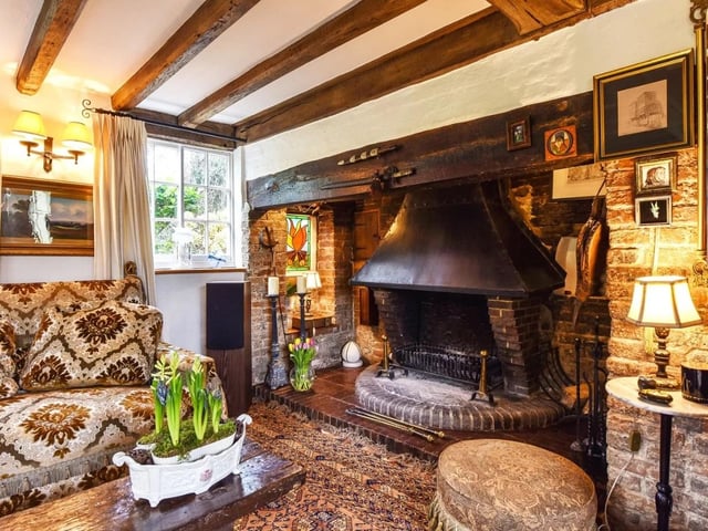 The drawing room has an inglenook fireplace and woodburning stove