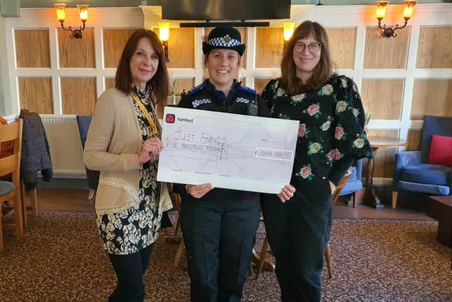 Police handing over the £500 donation to the Eastbourne-based charity. Picture from Sussex Police