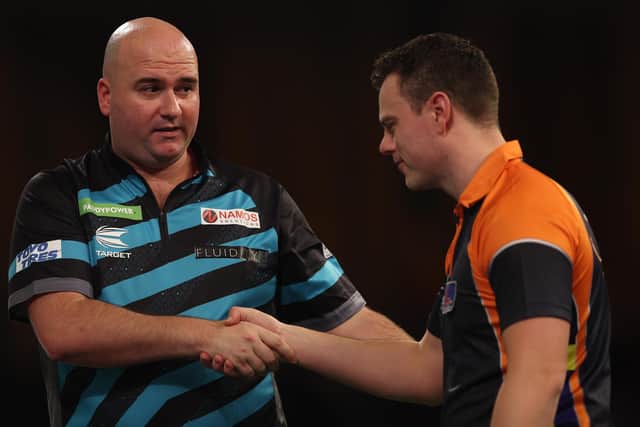 Rob Cross of England is congratulated by Jeremy de Graaf of the Netherlands after their match at the Paddy Power World Darts Championship at Alexandra Palace (Photo by Warren Little/Getty Images)