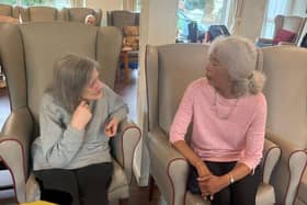 Volunteer Sandra Reakes shares a friendly chat, brightening afternoons with conversation, laughter, and genuine companionship.