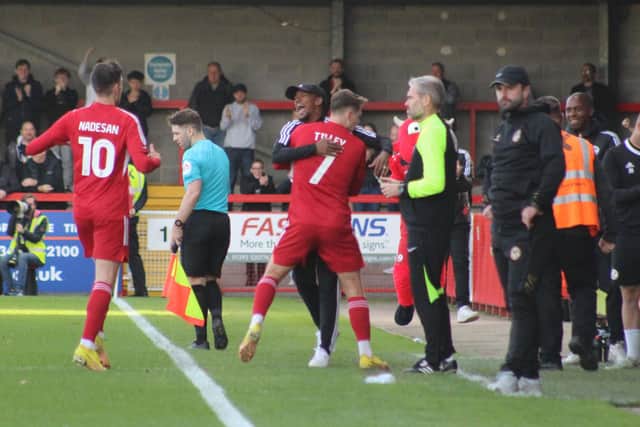 James Tilley ran to celebrate with interim manager, and club legend, Lewis Young after the opening goal. Photo: Cory Pickford