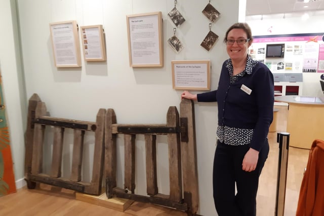 Claire Lucas, museum manager, with church gates made from wood that is nearly 1,000 years old