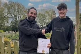 Connor collects his certificate from Paradise Park's head gardener, Simon Croucher.