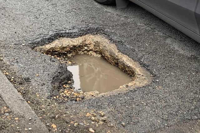 One of the dangerous potholes in Junction Road, Burgess Hill. Photo: Revd Stephen MacCarthy
