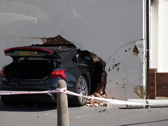 Three people injured after car crashes into wall of house in Eastbourne - in pictures