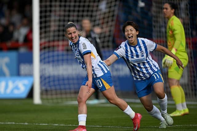 Jelena Cankovic of Brighton & Hove Albion celebrates scoring her team's third goal with teammate Kiko Seiko against Arsenal
