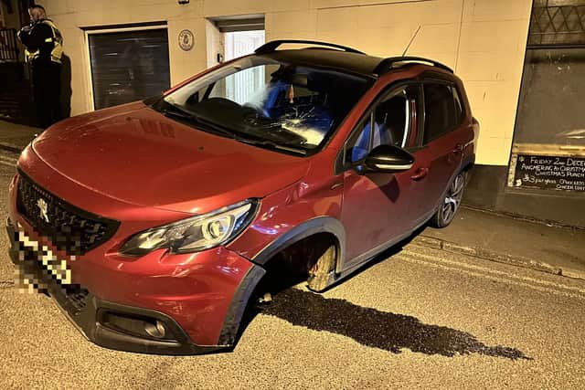 A vehicle reportedly collided with a parked car and the pub wall – sparking a response from police officers, who closed the road.