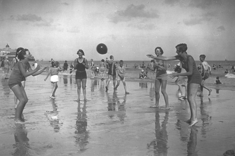 Young holidaymakers playing ball on the beach at Eastbourne in 1930