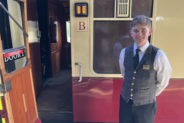 Dec welcomes passengers aboard the luxurious Pullman coach