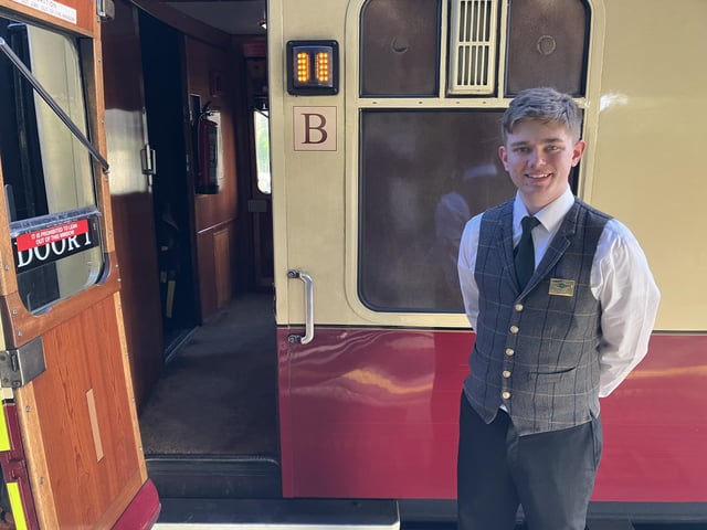 Dec welcomes passengers aboard the luxurious Pullman coach