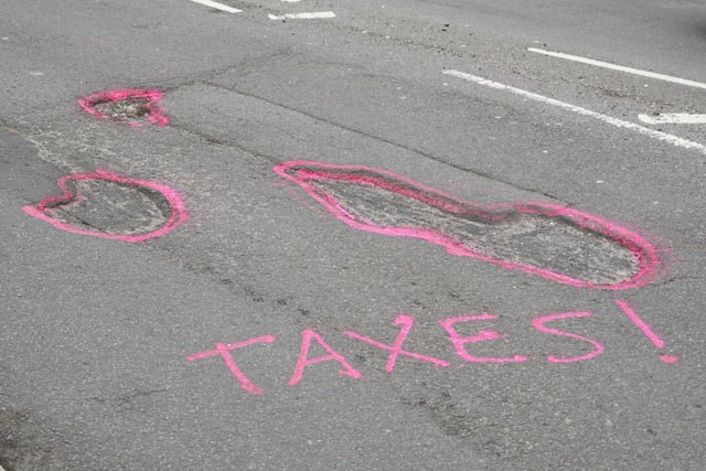 Graffiti seen in Chichester on Saturday, April 6, urging West Sussex County Council to fix several large potholes