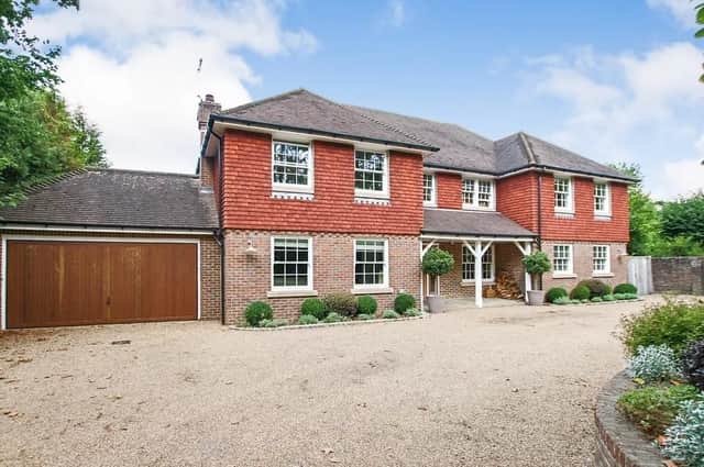 The property has an 'in and out' driveway that offers ample parking and a garage