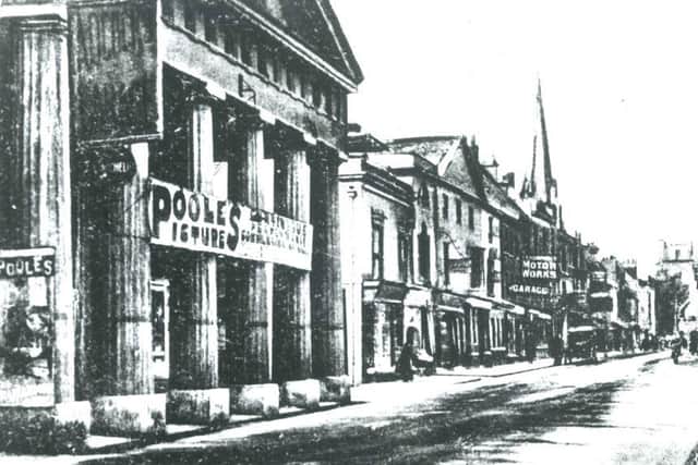 View of East Street from the Corn Exchange towards the Cross, Chichester. The photo shows the building decorated with a large banner advertisement for Poole’s Picture Palace in 1911. Picture: The Novium Museum