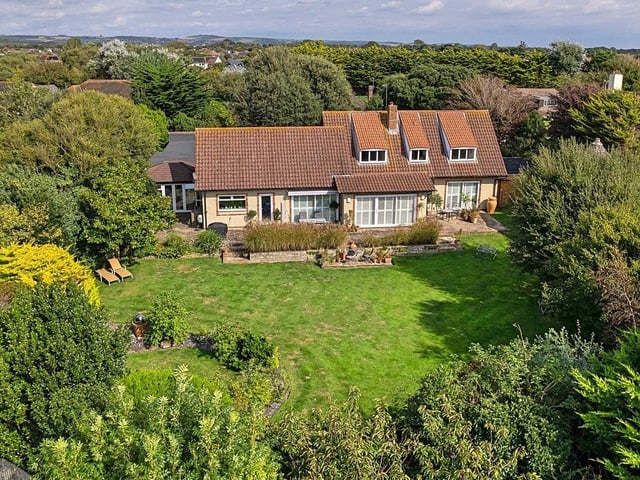 This spacious, four-bed detached house is situated in the sought-after Kingston Gorse private estate. It has four reception rooms, a modern kitchen/family room and a pool room/gym with swim spa. It has a guide price of £1.6million.