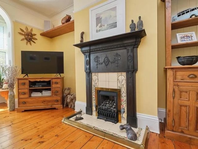 The living room is bright and airy, boasting wooden flooring, gas fire with stunning original cast iron surround, original picture rails and bay window.