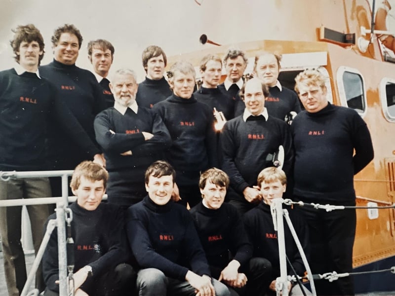 Newhaven Lifeboat crew, 1985. Featured top row, left to right: Andrew McQueen, Chris Bird, Mike Beach (Mechanic), Steve Kent, Ian Johns, Derek Payne, Paddy Boyle (Second Coxswain). Middle row, left to right: Len Patten (Coxswain), Tony Jefferies, Brian Ashdown (Second Mechanic), Rick Ward. Front row, left to right: Paul Legendre, Phill Corsi, Lol Deakin and Nick Gentry.