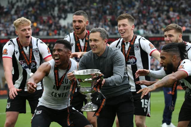 Grimsby Town manager Paul Hurst (centre) celebrates after the Mariners' National League play-off final win over Solihull Moors in June. Picture by Steve Bardens/Getty Images
