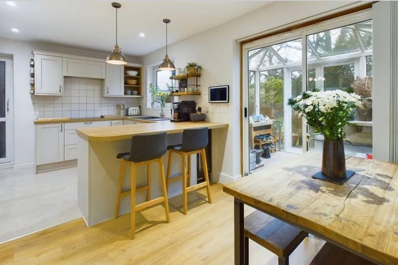 The kitchen is fitted with a stylish range of floor and wall mounted units, with a selection of integrated appliances and a breakfast bar, whilst also offering space for a dining table, which makes it the perfect room for entertaining