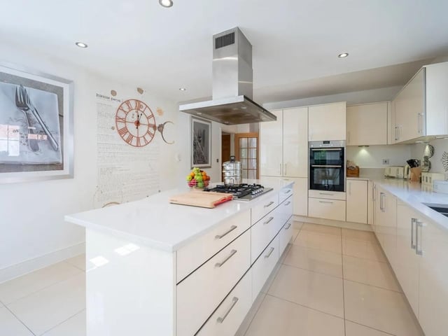 The large kitchen/dining room has a central kitchen island