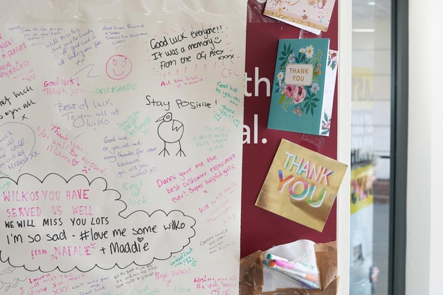 Customers have written messages for the staff on a 'goodbye wall'.
