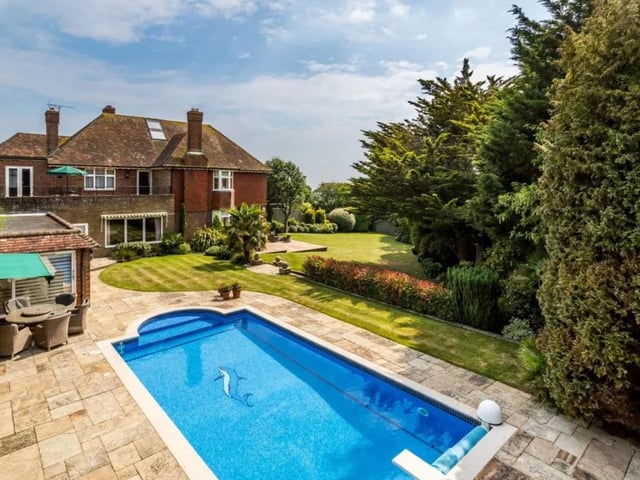 The house is on the market with Hamptons - Brighton & Hove Sales for a guide price of £2,950,000.
Dating back to the 1930s with later editions it has been in the same family for over 40 years. The landscaped rear gardens are a particular feature of the property, laid out on two levels; the outdoor swimming pool is sited on the top level, enjoying views to the south, and has a paved surround with plenty of space for sun loungers
