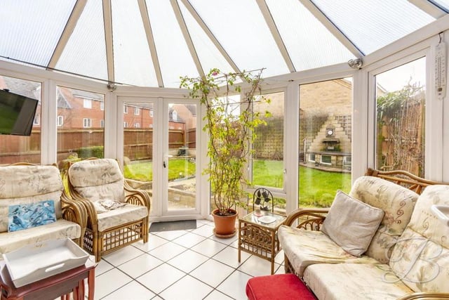 Here is the bright comfortable conservatory, which sits at the back of the house and can be accessed via the living room. The floor is tiled, and patio doors lead into the back garden.