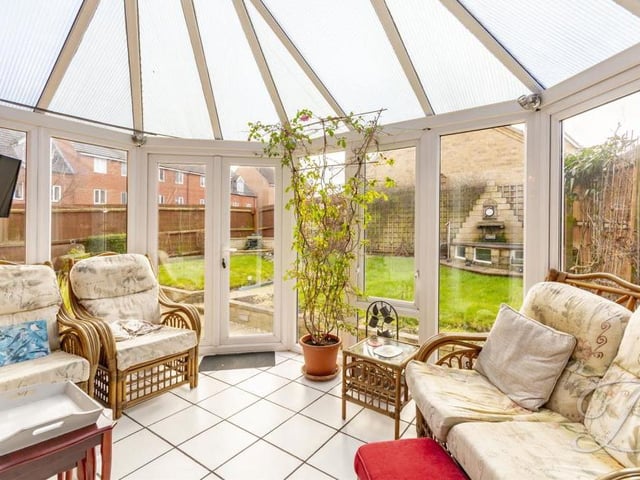 Here is the bright comfortable conservatory, which sits at the back of the house and can be accessed via the living room. The floor is tiled, and patio doors lead into the back garden.