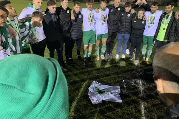 Chi's management and players gather in the centre circle after the whistle - with a T-shirt featuring Graeme Gee and a promotion medal placed on the ground | Picture: Steve Bone