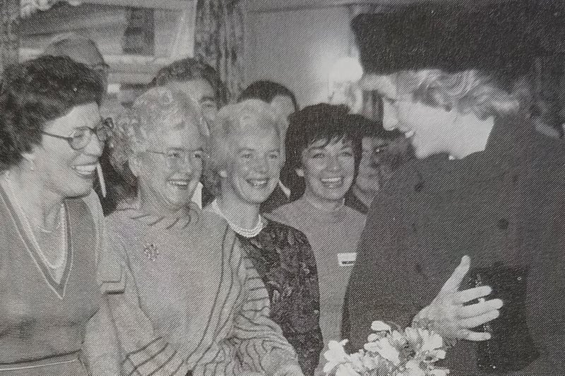 Diana, Princess of Wales, meets a group of volunteers at St Barnabas House in 1985