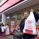Tracey Chorley and her daughter Caitlin, ten, with their bargains, outside Woolies in Bognor in December 2008