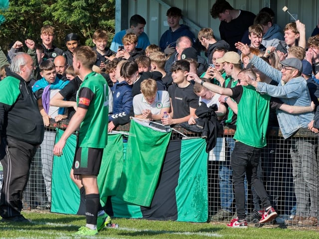 Burgess Hill Town players, fans and staff celebrate surviving in the Isthmian south east division at the end of their 0-0 draw with Beckenham