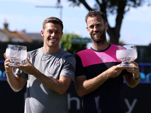 Michael Venus of New Zealand (R) and Neal Skupski of Great Britain (L) pose for a photo with their winners' trophies after victory against John Peers of Australia and Matthew Ebden of Australia in the Men’s Doubles Final match on Day Seven of the Rothesay International Eastbourne (Photo by Charlie Crowhurst/Getty Images for LTA)