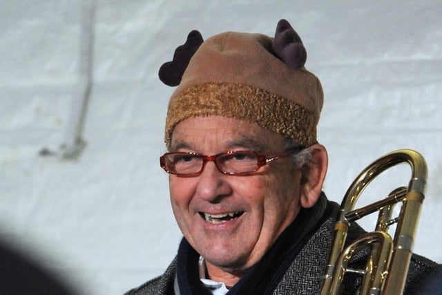 A member of the band with festive headgear