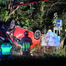 Firefighters recover an overturned car, following a traffic incident on A24 Horsham Road, near Findon.