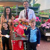 Rosy Lloyd from St Mary's Catholic Primary School at Mayberry Garden Centre collection the Budding Foundation’s donation. 