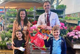 Rosy Lloyd from St Mary's Catholic Primary School at Mayberry Garden Centre collection the Budding Foundation’s donation. 