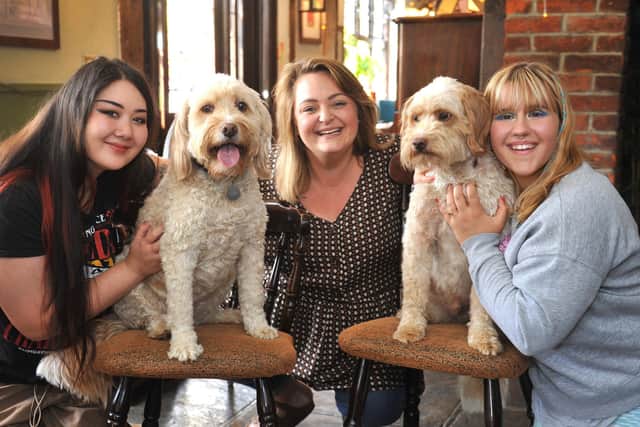 Landlady of Horsham's King's Arms pub Jodie Munday (centre) with colleagues Elianna Pearson and Megan Chapman, along with Jodie's dogs Rufus and Gina. The pub is a finalist in the Great British Pub Awards in the 'Best Pub For Dogs' category. SR2307191 Photo by S Robards/Sussex World
