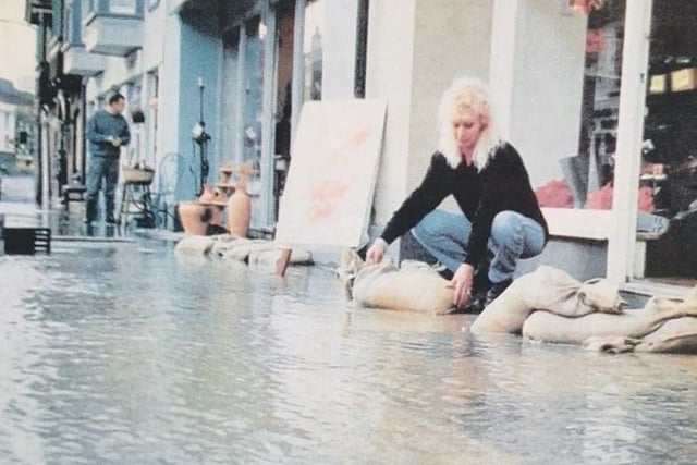 Diana Russell surveying the sandbags outside her shop in The Hornet