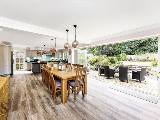A wall of bi-fold doors allows the heart of the home to merge with the garden