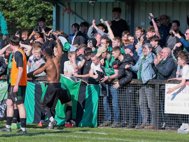 Burgess Hill Town players, fans and staff celebrate surviving in the Isthmian south east division at the end of their 0-0 draw with Beckenham